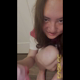 Emi squats on the floor in a Princess Peach shirt while a Princess Peach plushie watches her poop, then she holds up the turd with Peach and smiles for the camera. Vertical format video. Over 13 minutes.